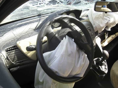 Damaged car with deployed airbags